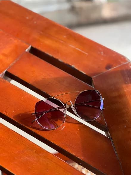 Sunglasses on red surface
