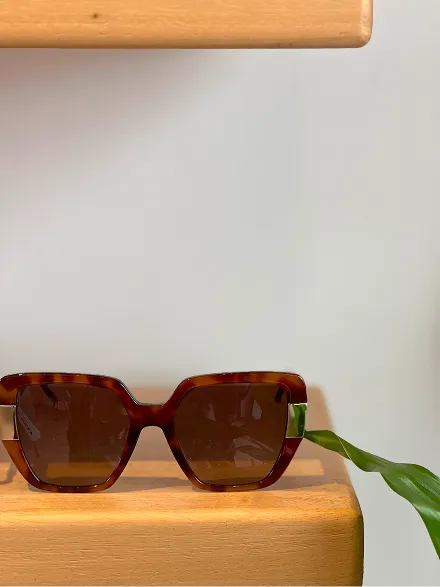Sunglasses on red surface