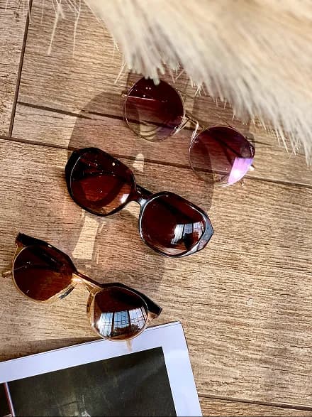 Sunglasses on red surface